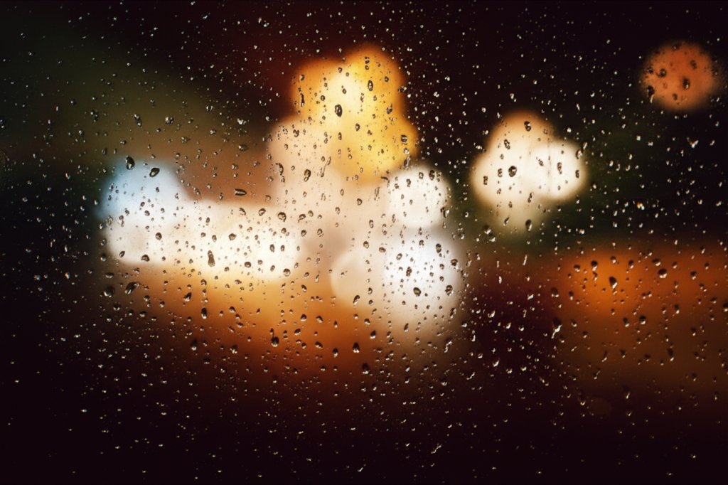 Rain-soaked city street at night